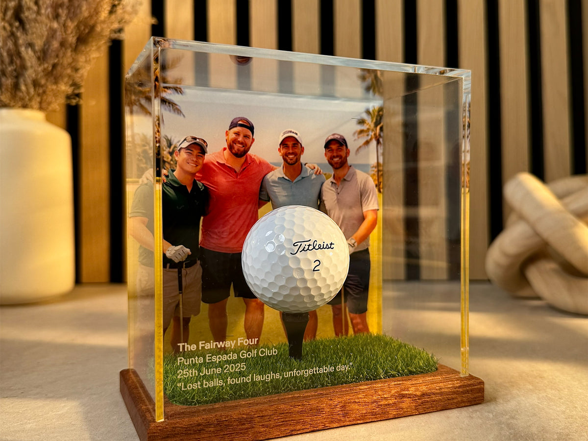 a group of men in a glass case with a golf ball