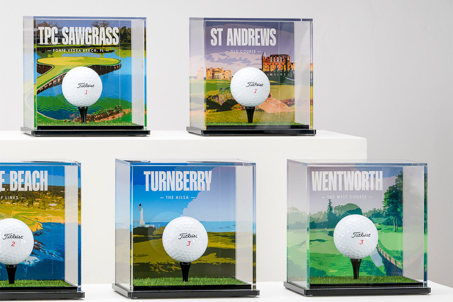 a group of golf balls in clear cases