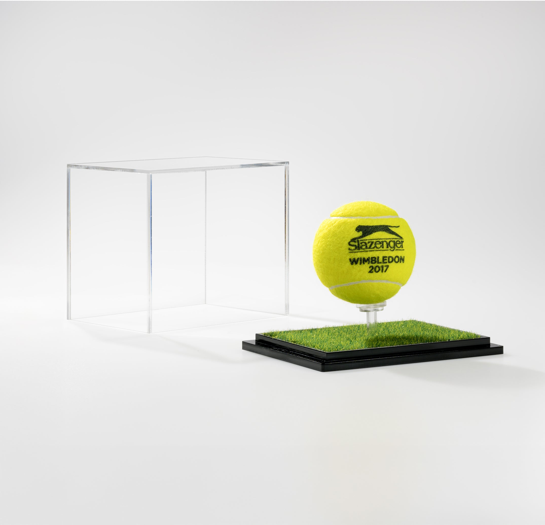 Tennis ball with Wimbledon 2017 branding in a clear display case.