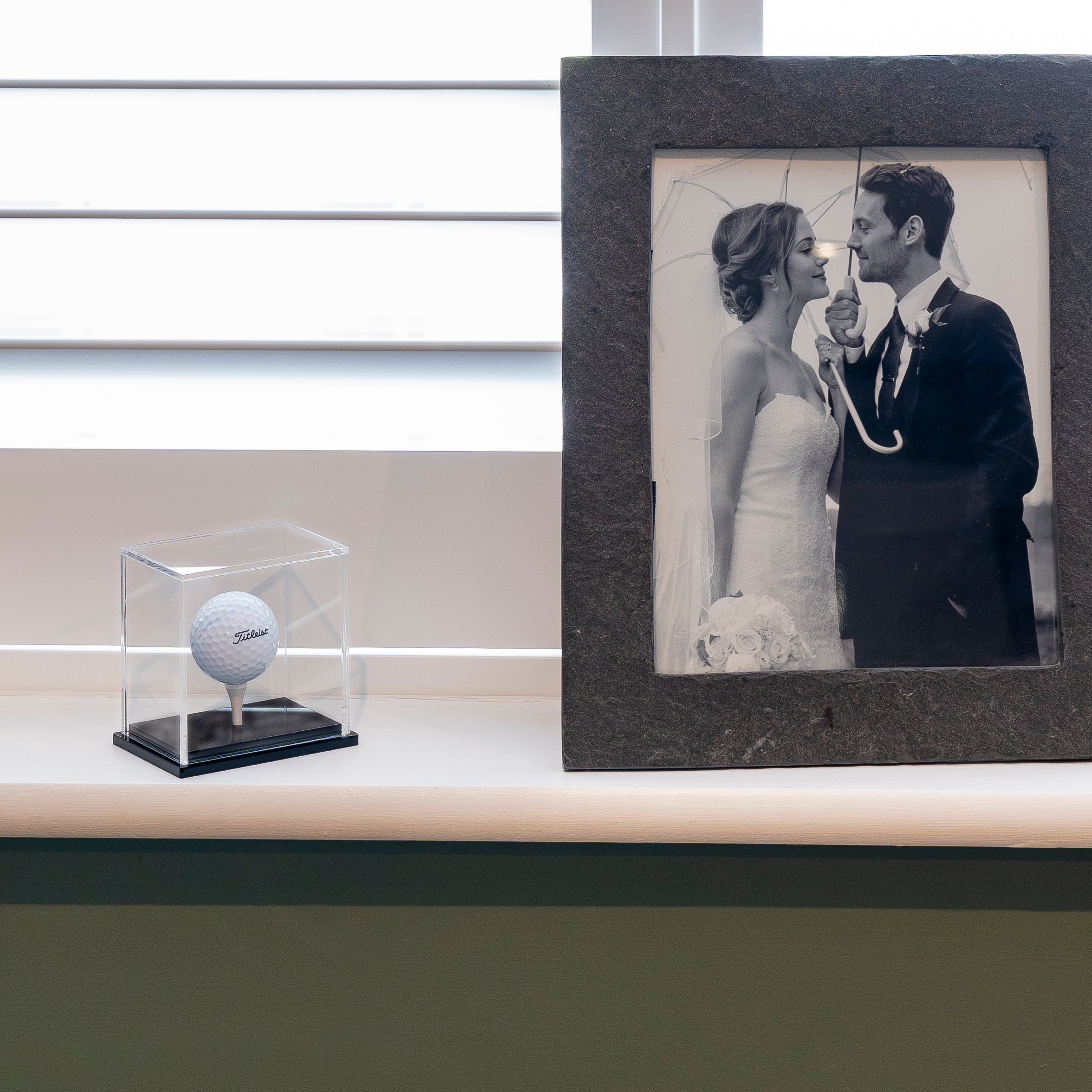 Black Base Display Case on Shelf with Photograph