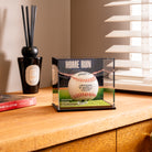 a baseball in a glass case on a counter