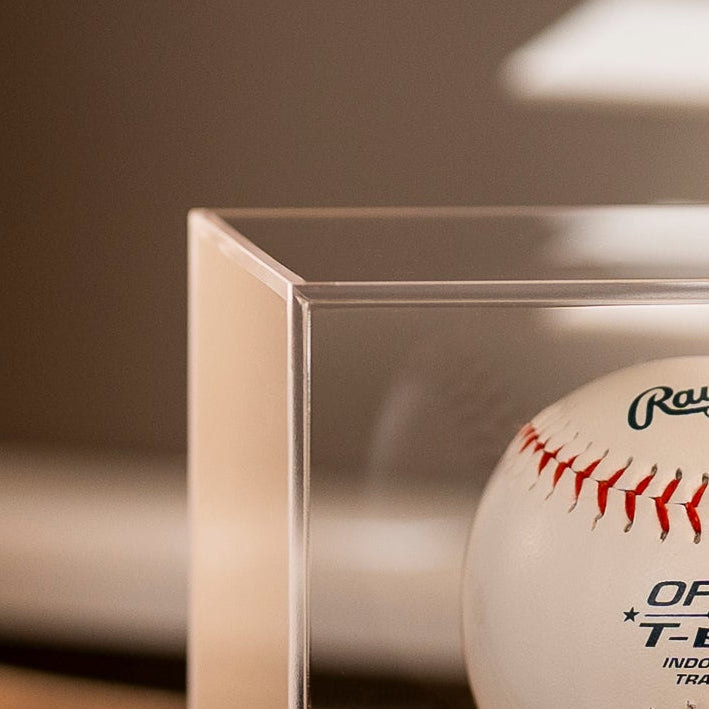 Baseball in a clear display case with a blurred background