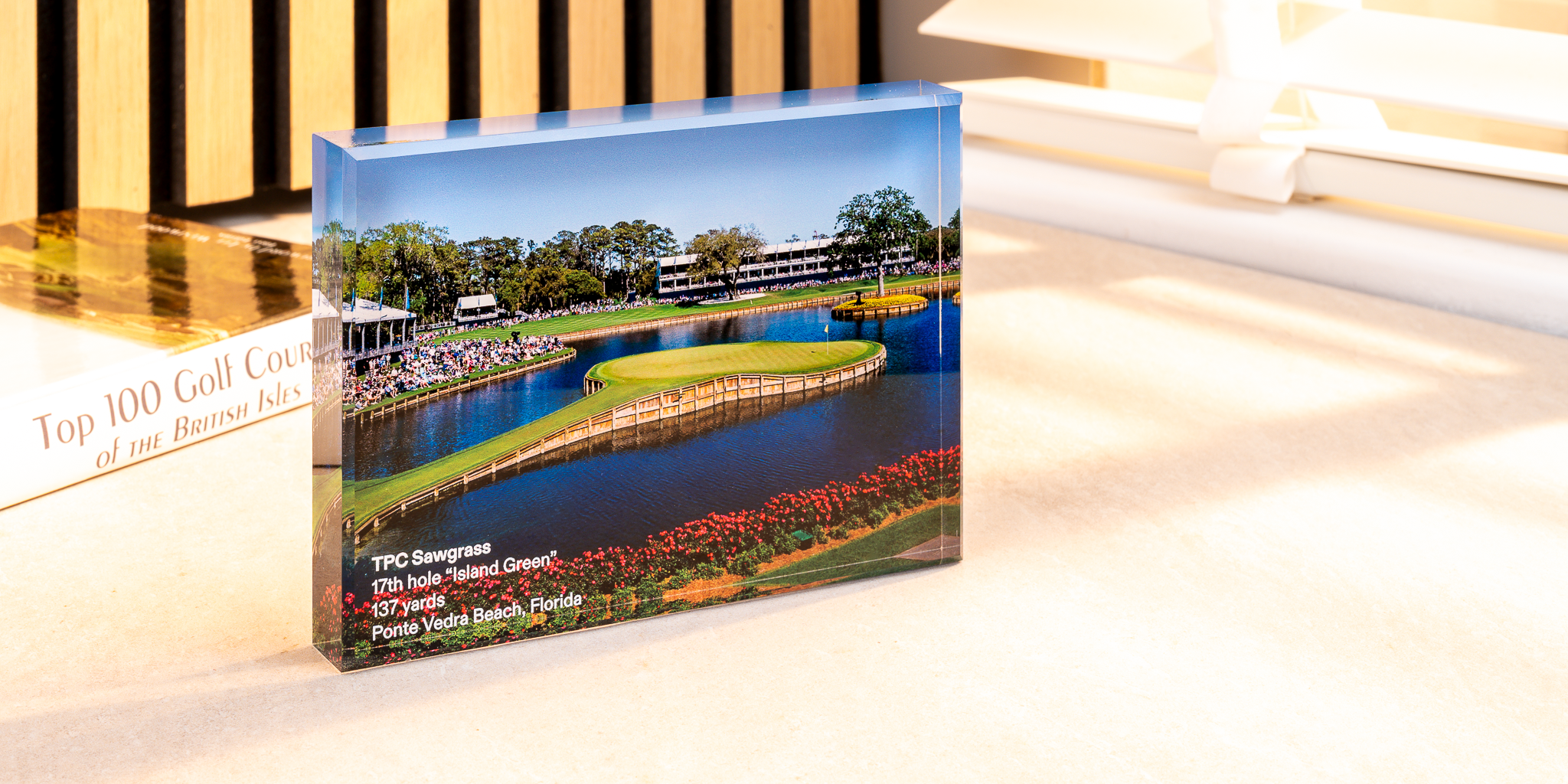 a rectangular acrylic block with a bridge over a pond
