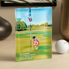 a glass trophy with a golf ball and a picture of a woman on the golf course