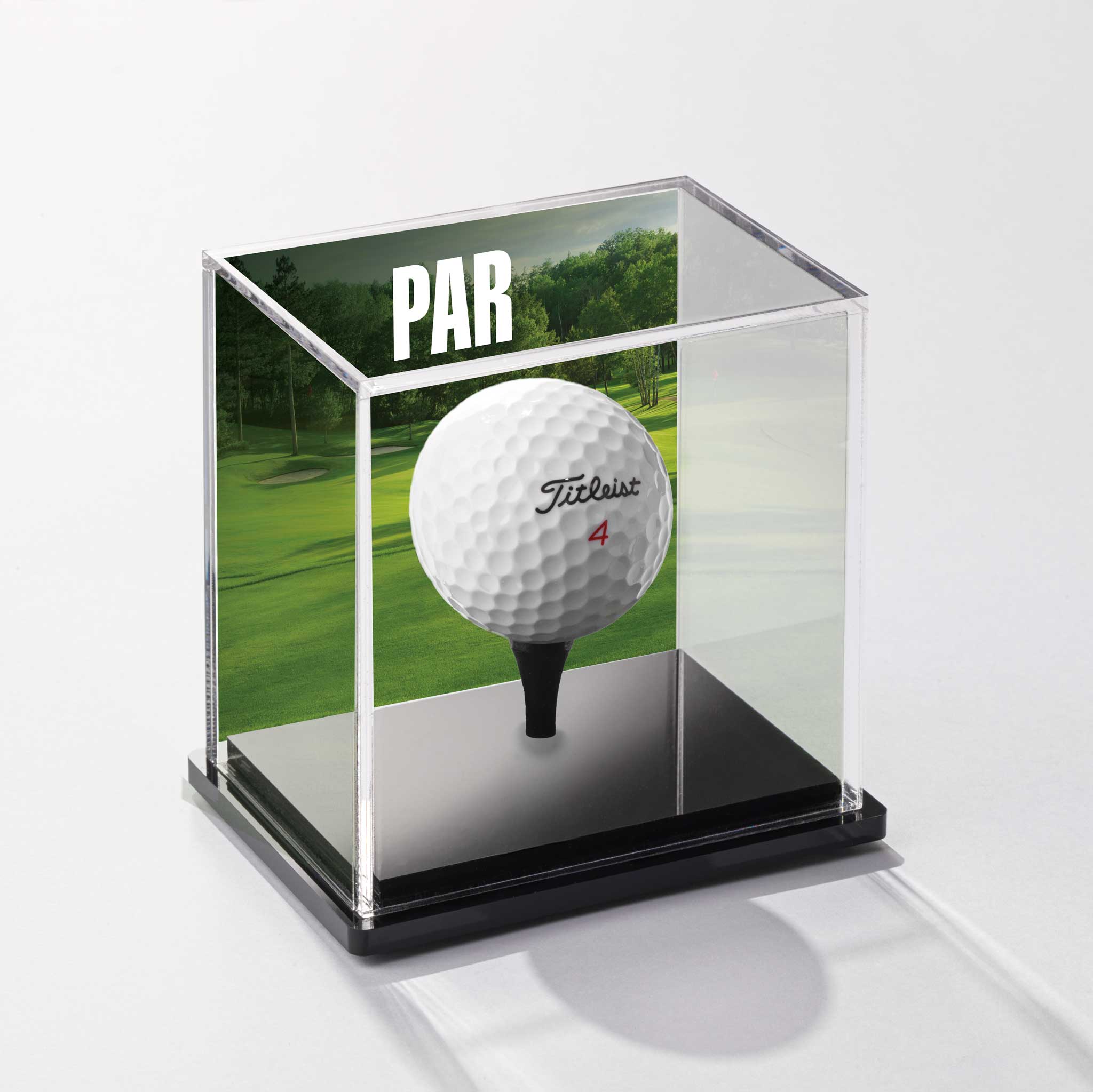a golf ball in a glass case