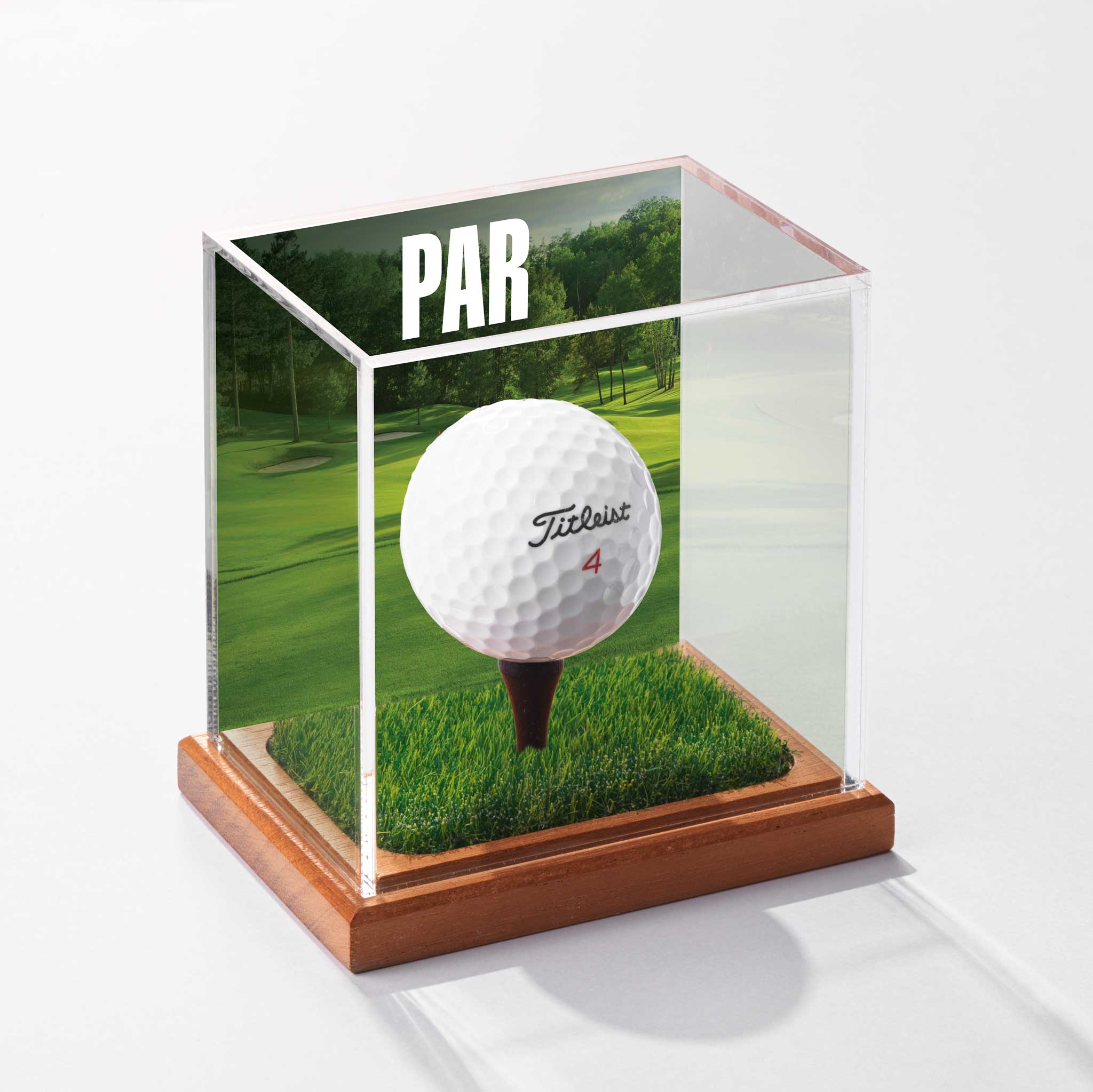 a golf ball in a glass case