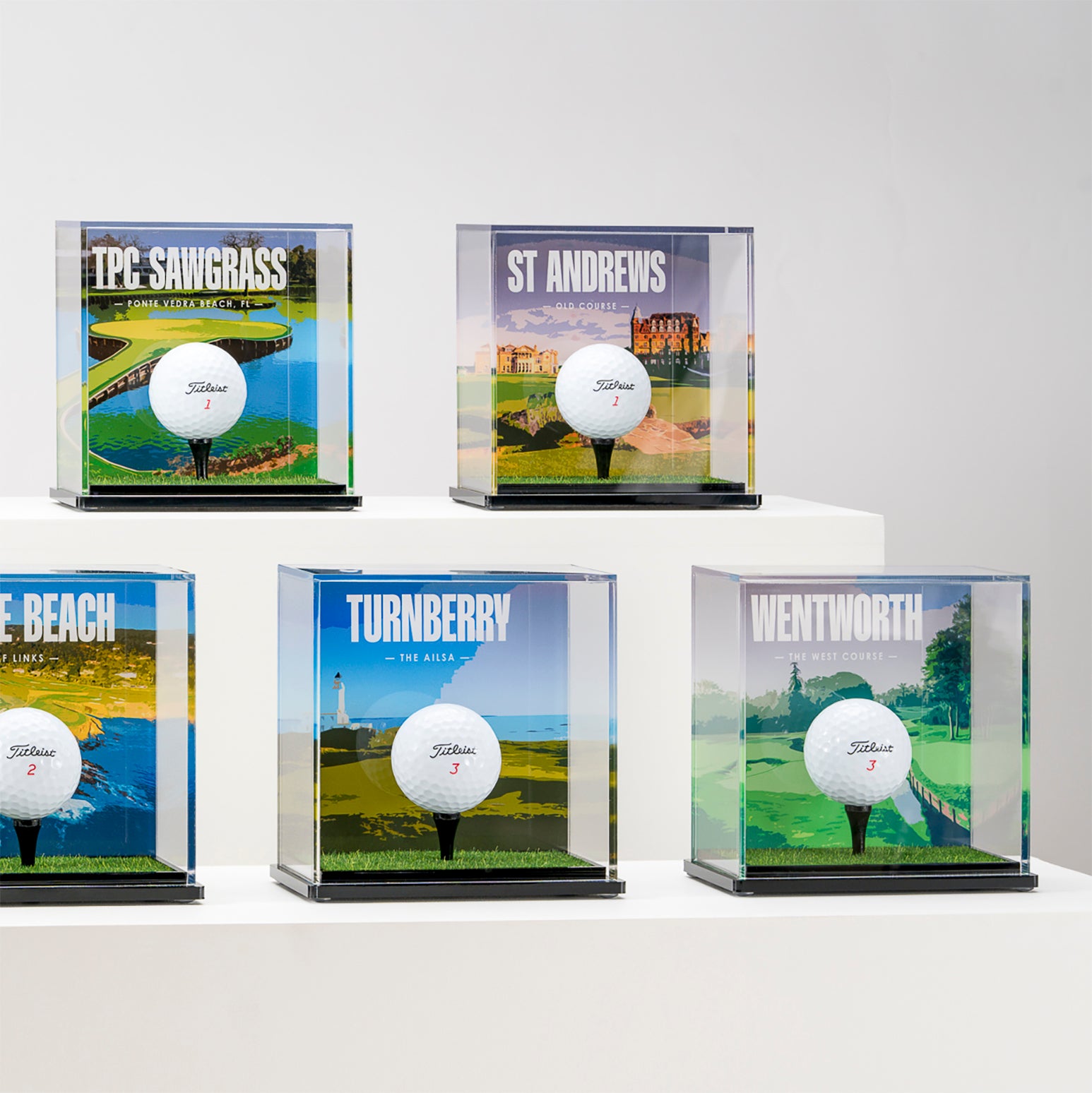 a group of golf balls in clear cases